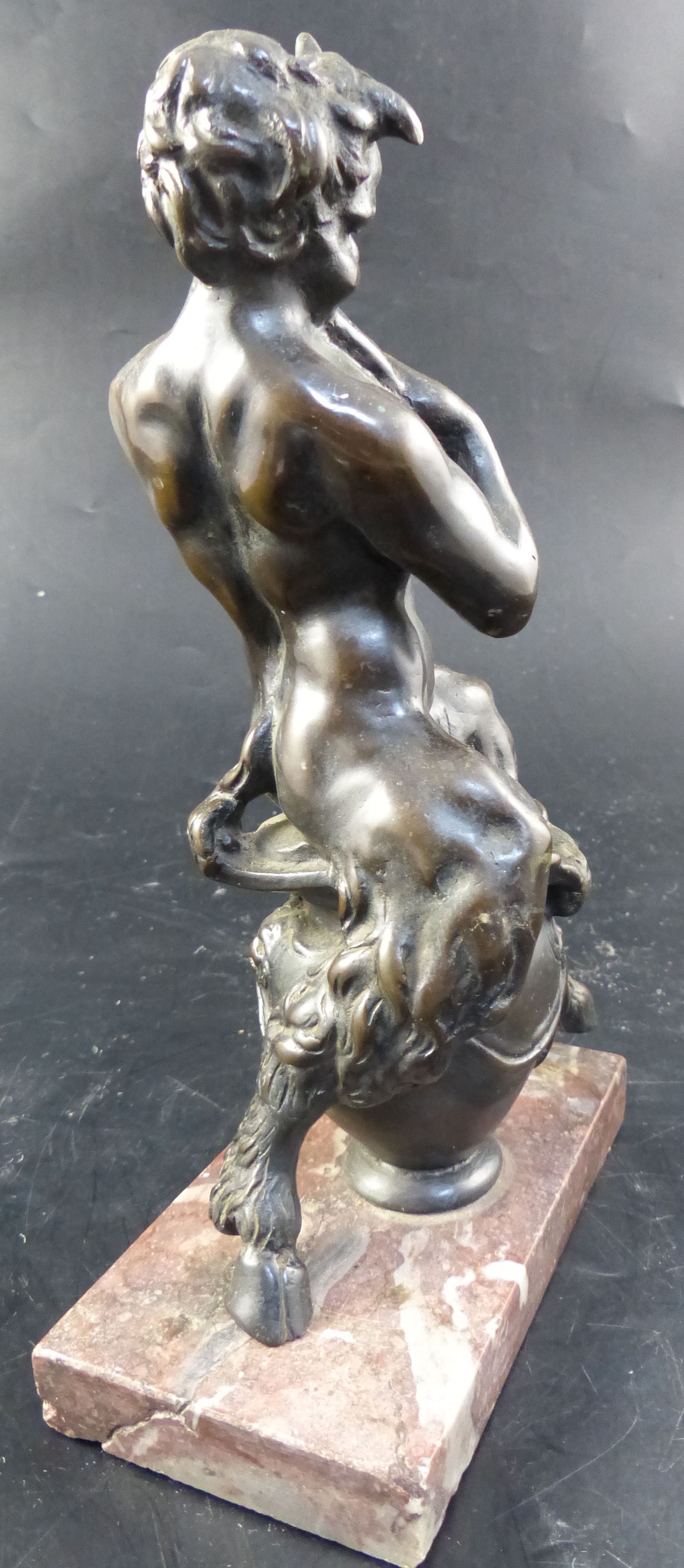 After Frederick Pomeroy (1856-1924). A 19th century Italian bronze model of a satyr playing pan pipes, overall height 24.5cm.